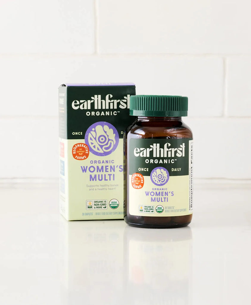 Earthfirst Organic Women's Multi Once Daily vitamins in a brown bottle with a matching green box, promoting health support.